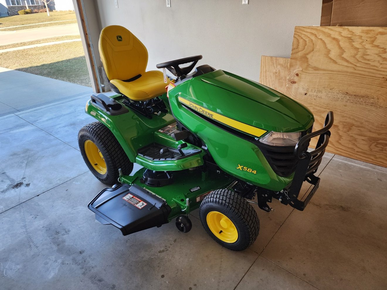 The family's John Deere X584 riding tractor in their garage before it was sold